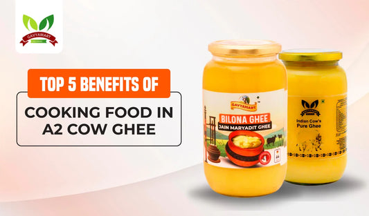 Two jars of A2 cow ghee with labels, one labeled Bilona Ghee and the other labeled Indian Cow's Pure Ghee.
